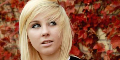 Blond girl with autumn background